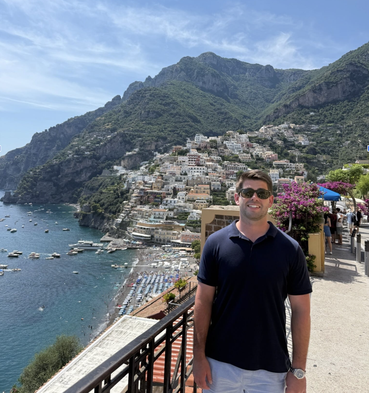 Kevin Hughes in Positano, Italy with the Amalfi coast in the background